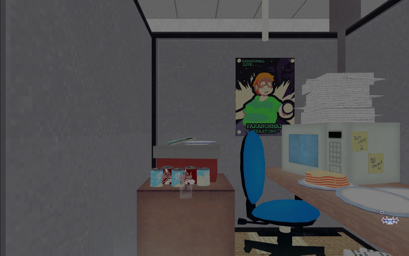 Cluttered office desk with posters, notes, cans, and cake